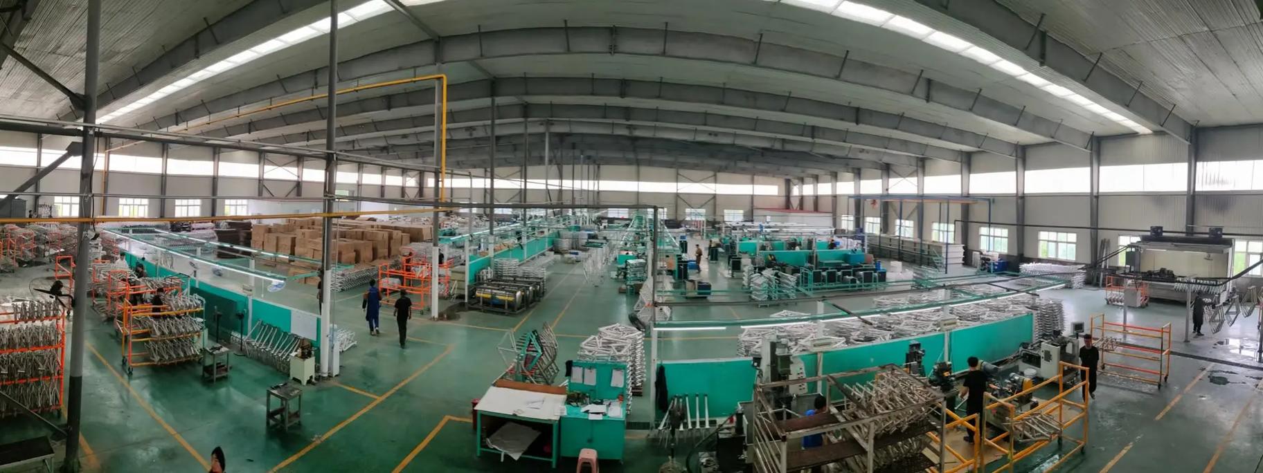 Panoramic view of a large-scale road bike manufacturing factory with production lines and equipment, showcasing capable manufacturers from the list of road bike manufacturers